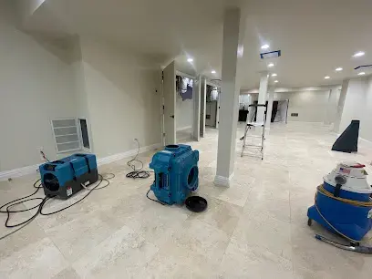 Dehumidifier and air mover drying a finished basement in Jamaica, NY